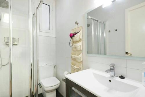 a bathroom with a sink and a toilet and a mirror at Apartamento Noemi in Barcelona