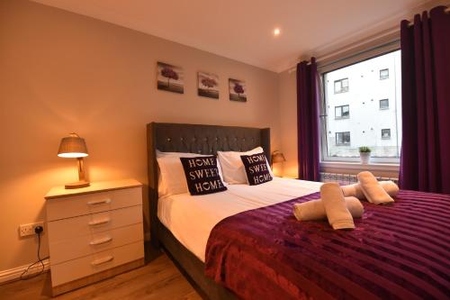 a bedroom with a large bed and a window at Royal Mile Apartment in Edinburgh