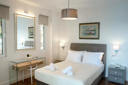 a bedroom with two beds and a desk and a mirror at Karalis Beach in Pylos