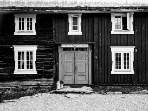 a wooden house with a door and two windows at Ivaregga Vinterstua in Tolga