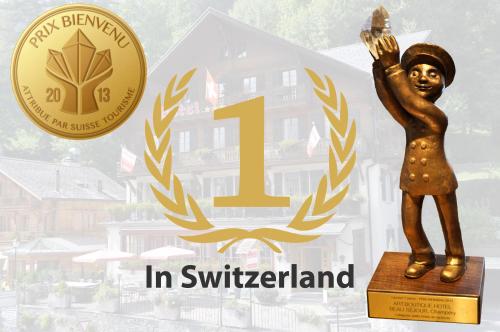 a bronze statue of a person with a torch at Boutique Hotel Beau-Séjour & Spa Superior in Champéry