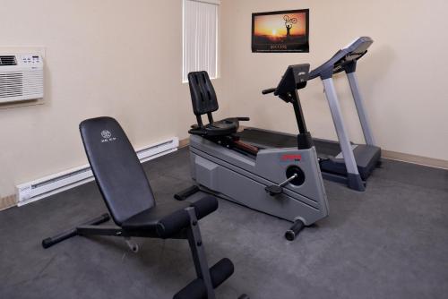 a room with a gym with two chairs and a treadmill at Cottonwood Inn and Conference Center in South Sioux City
