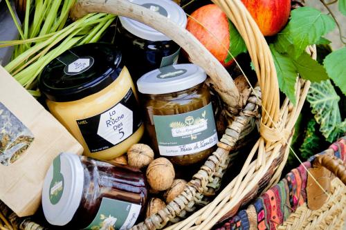 a basket filled with jars of food and fruits and vegetables at LA MONGEARDIERE in Ay