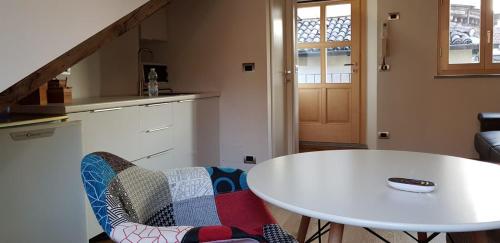 a white table and a chair in a kitchen at Una perla nel centro di Torino in Turin