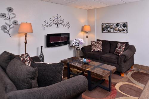 a living room with two couches and a coffee table at Cottonwood Inn and Conference Center in South Sioux City