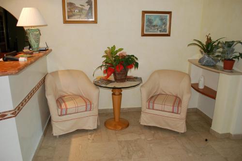 a room with two chairs and a table with plants at Hotel Ristorante La Terrazza in Lido di Camaiore