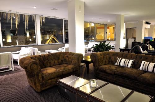 a living room with two couches and a table at Hotel Kandahar in Pas de la Casa