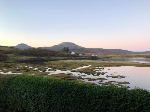 a view of a river with mountains in the background at Balmore in Dunvegan