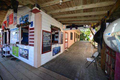 a building with a chair sitting outside of it at Seagrape Plantation Resort & Dive Center in West End