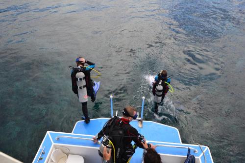 a group of people on a boat in the water at Seagrape Plantation Resort & Dive Center in West End