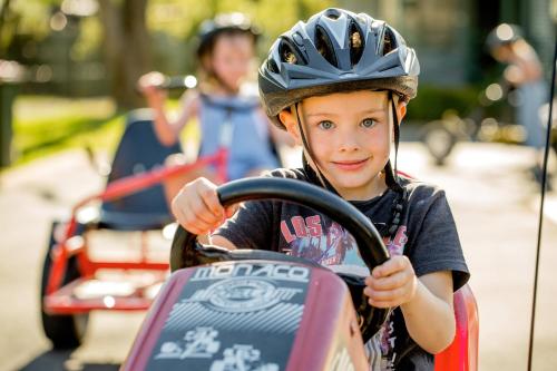 a young child wearing a helmet riding a bike at NRMA Ballarat Holiday Park in Ballarat