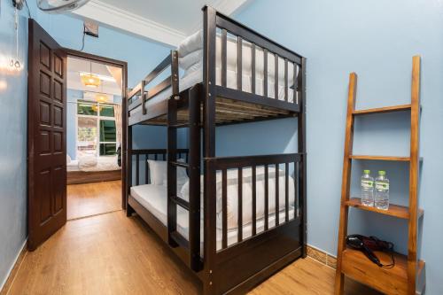 a room with a bunk bed and a staircase at Nusmile's Hostel and Travel in Hanoi