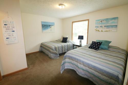 a bedroom with two beds and a window at Island Club #77 in Put-in-Bay