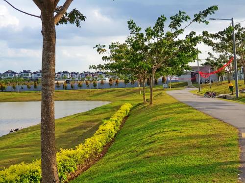a park with green grass and trees and a sidewalk at Selendang In Krubong Near Std Hang Jebat, MITC & UTEM in Melaka