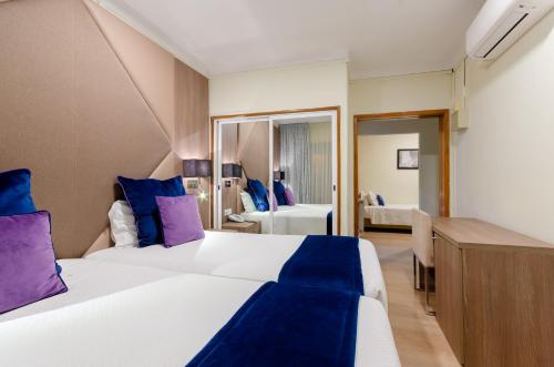 En eller flere senger på et rom på Hotel INN Rossio