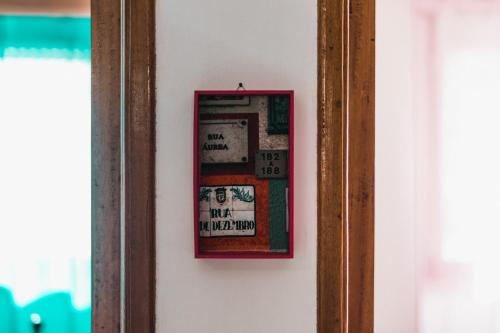 a picture frame hanging on a wall next to a mirror at Lisboa Manaia Home in Lisbon