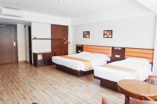 Кровать или кровати в номере Hans Inn Batam