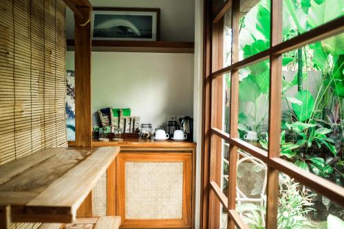 a room with a wooden bench and a window at Melali Bingin in Uluwatu