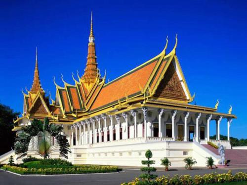a large white building with a pagoda on top of it at Okay Palace Hotel in Phnom Penh