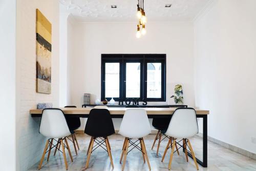 a dining room with a table and four chairs at In Homs 26 in Klang
