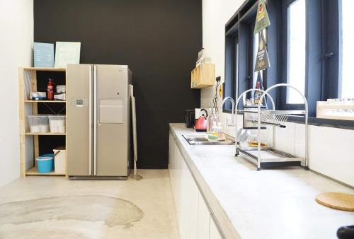 a kitchen with two sinks and a refrigerator at In Homs 26 in Klang