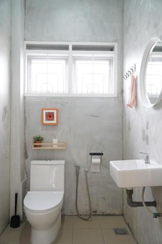 a bathroom with a white toilet and a sink at In Homs 26 in Klang
