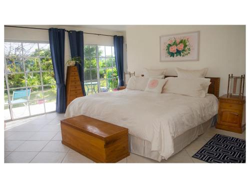 Un dormitorio con una gran cama blanca y una ventana en Silver Point Villa, en Freeport