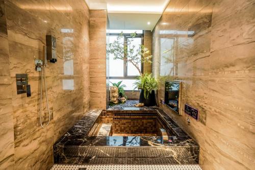 a large bathroom with a shower and a bathtub at Shu Xin Motel in Nantou City