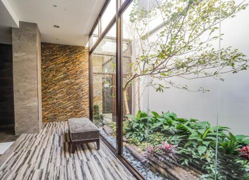 a room with a bench and plants at Shu Xin Motel in Nantou City
