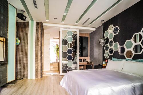 a bedroom with a large white bed in a room at Shu Xin Motel in Nantou City