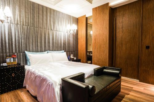 a bedroom with a large bed and wooden walls at Shu Xin Motel in Nantou City