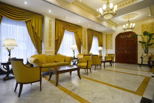 a living room with a couch and chairs and a table at Zanhotel Europa in Bologna