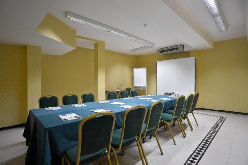 a conference room with a long table and chairs at Zanhotel Europa in Bologna