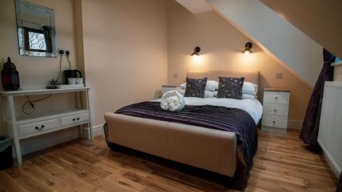 a bedroom with a bed with a cat sitting on it at The Pebley Inn in Chesterfield