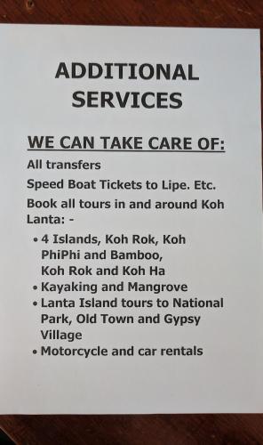 a white sign with the instructions about additional services at SER-EN-DIP-I-TY - SHA Extra Plus in Ko Lanta