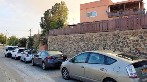 a row of cars parked on the side of a street at Dead Sea Sun Guest House in Arad