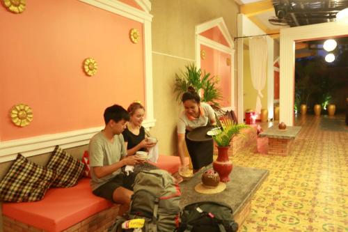 a group of people sitting in a living room at Central Indochine D'angkor Hotel in Siem Reap