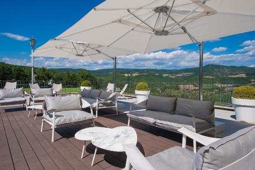 a group of chairs and umbrellas on a deck at La Reggia Sporting Center Hotel in Cascia
