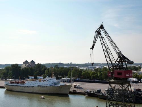 a cruise ship is docked next to a crane at Laivahostel S/S Bore in Turku