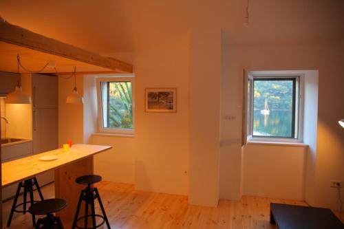 a room with a kitchen with a counter and a window at Apartmani Soline in Goveđari
