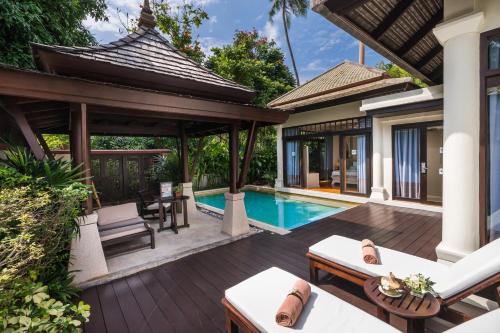 a villa with a swimming pool and a patio at Melati Beach Resort & Spa in Choeng Mon Beach