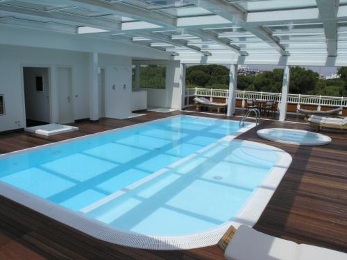 a large swimming pool on the deck of a building at Aparthotel England in Riccione