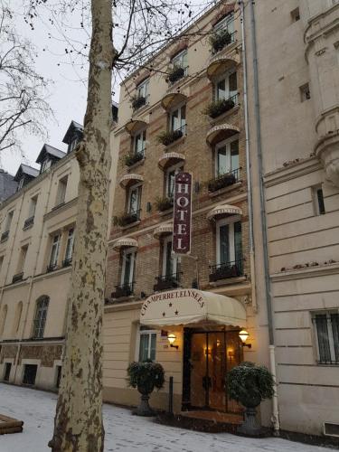 a building with a hotel sign in front of it at Hotel Champerret Elysees in Paris
