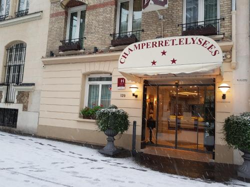 a store with a sign on the front of a building at Hotel Champerret Elysees in Paris