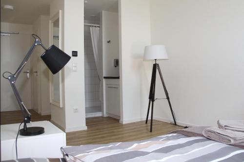 a room with a bed and a lamp in it at Quartier36 in Schleswig