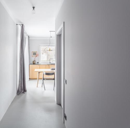 a hallway leading to a kitchen and a dining room at Minimalist. Apartment & Studio in Šiauliai