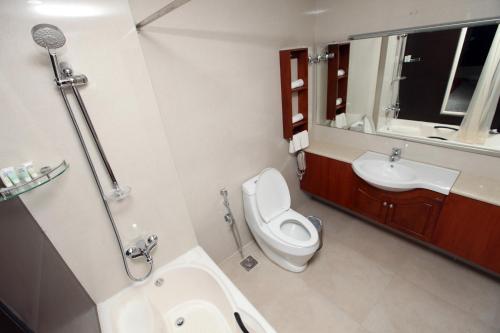 a bathroom with a toilet and a sink at Hotel All Season in Kollam