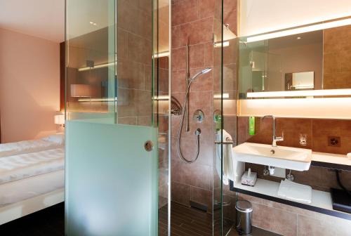 a bathroom with a shower and a sink at b-smart motel Sevelen in Sevelen