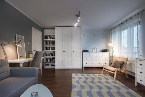 a living room with a couch and a dresser at Willa Rybaczówka z ogrodem in Puck