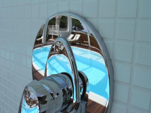 a reflection of a swimming pool in a mirror at Aparthotel England in Riccione